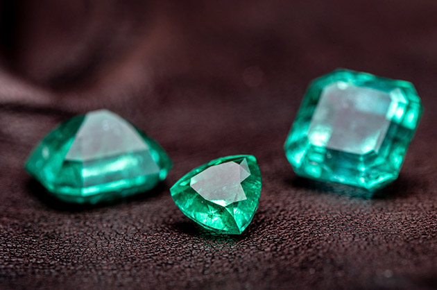 três pedras de diamantes verdes em formatos diferentes 
